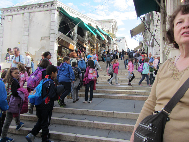 Kids on a field trip tramp up the Rialto Bridge.