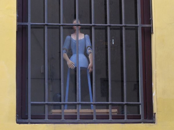 Manequin behind bars