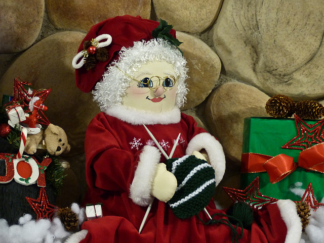 Mrs. Claus busily knitting