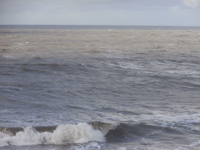 Just a slight sunny patch on the rolling grey sea