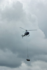 Helicopter lifting rocks to the top