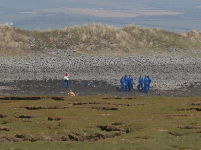 Some people were investigating parts of the beach