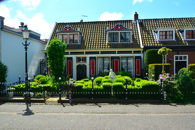 House with garden and statue