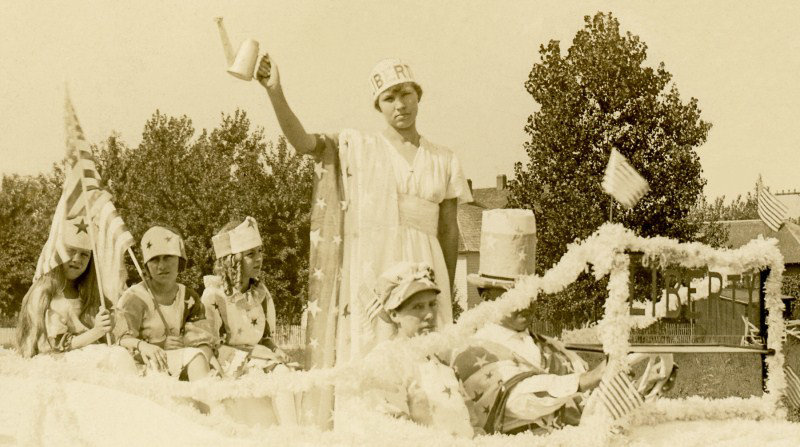 Lady Liberty and Her Family in a Decorated Parade Car (Cropped)