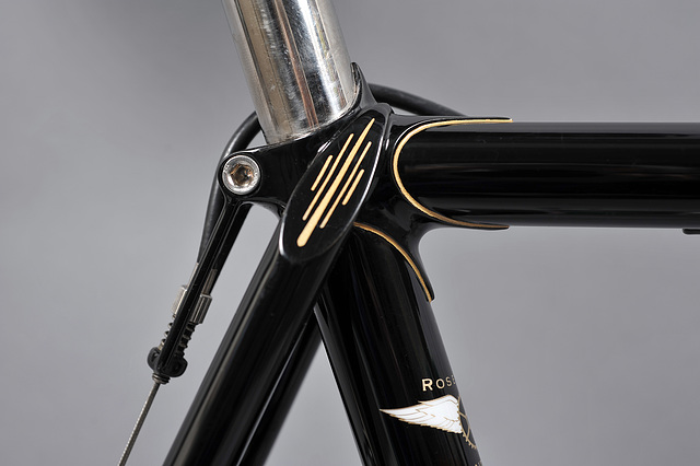 Seat cluster features wrap over seat stays with decorated top eyes.