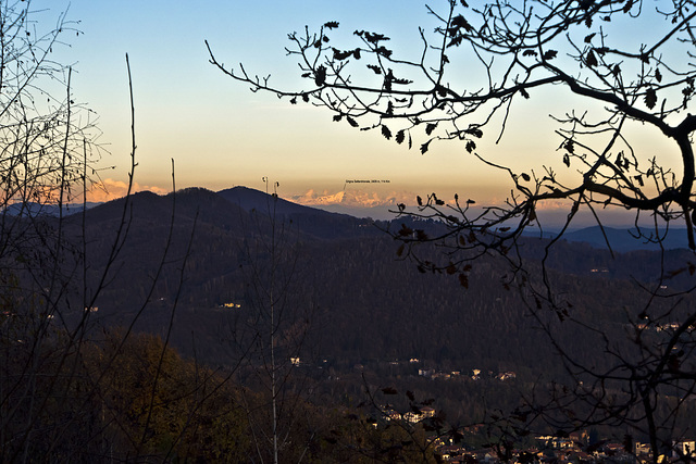 Advancing the darkness, emerge the Lombard mountains with the first snow