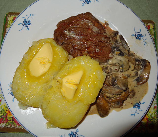Fillet steak, jacket potatoes, and mushrooms cooked in a whiskey and mustard cream source