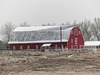 Red barn on a cold, foggy, snowy day
