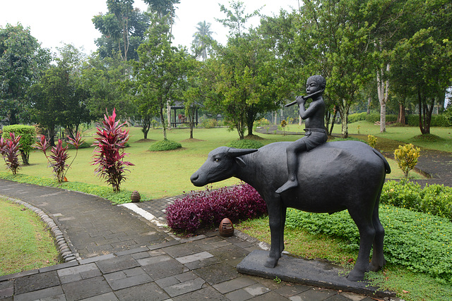 Indonesia, Java, Boy Riding a Cow - Sculpture in the Park of Borobudur