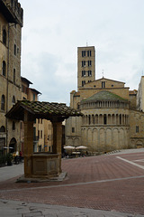 Italy, Arezzo, Water Well and Church of Santa Maria della Pieve on Piazza Grande