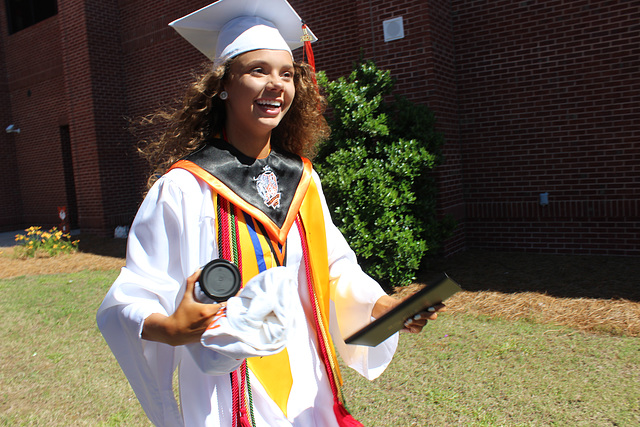 SHE DID IT.. !!  YOU GO GIRL ...:)  our Grand Daughter moments after she has graduated from High School !!!