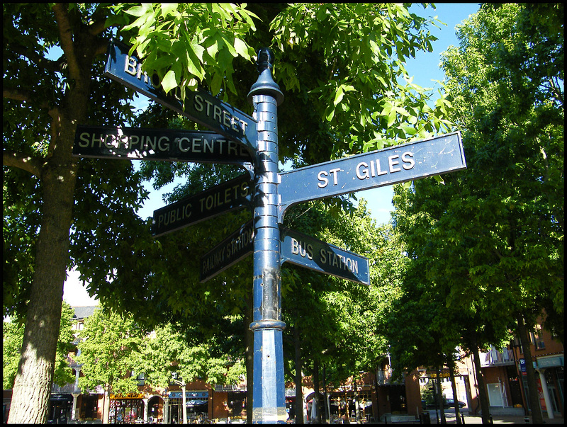 sunlight on an old blue signpost