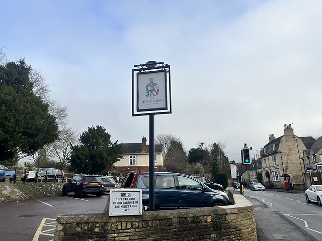 The Kings Arms pub sign and the High Street, Prestbury, Gloucestershire