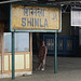Shimla Station Sign Framing a Passenger