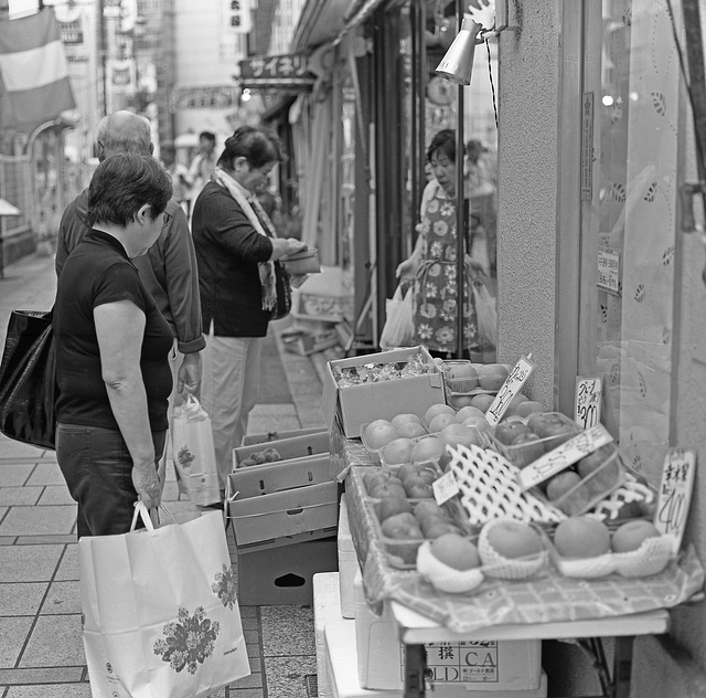 People gather round the fruits in season