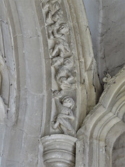 lawford church, essex , lively acrobats and musicians on window moulding around a c14 chancel window