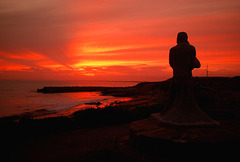 Lovers looking out into the sunset.