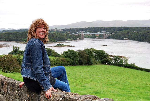 Sitting on a wall overlooking Menai straits