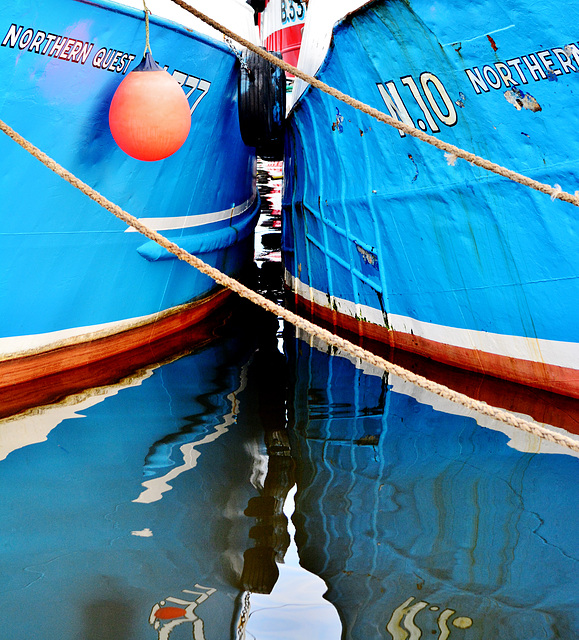Two reflected blue boats