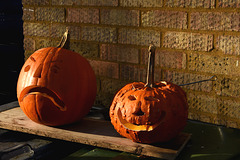Two pumpkins against the wall -