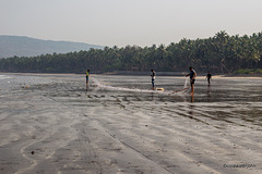 Fishermen on Nandgaon beach preparing their nets
