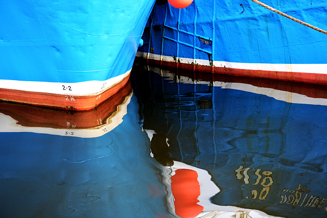 Two reflected blue boats