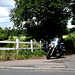 White fence, black motorbike
