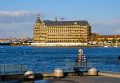 Gentleman sitting on bench and Haydarpasa Train Station