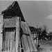 man at house by bombed bridge