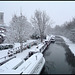 snow by a black canal