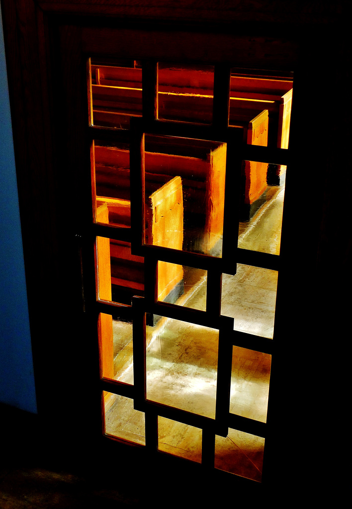 Deco door with pews beyond