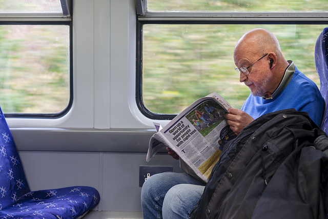 Bloke Reading the 'Metro' on the Train