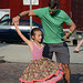 A father-daughter dance in front of the stage