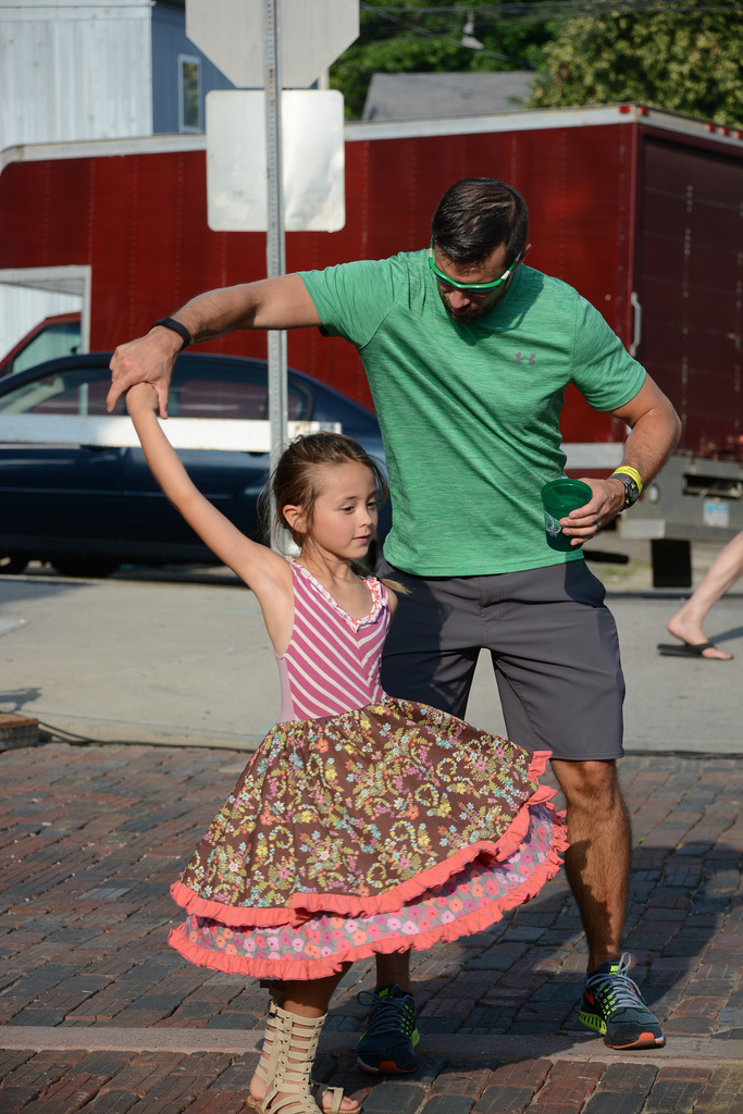 A father-daughter dance in front of the stage
