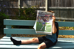 Sitting on a bench reading the wonderful news in the paper!!