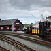 The wall of Porthmadog station as Lilla approaches with a work train.