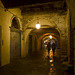 In the evening, walking in silence under the arches of the medieval village of Piazzo, Biella (Italy)