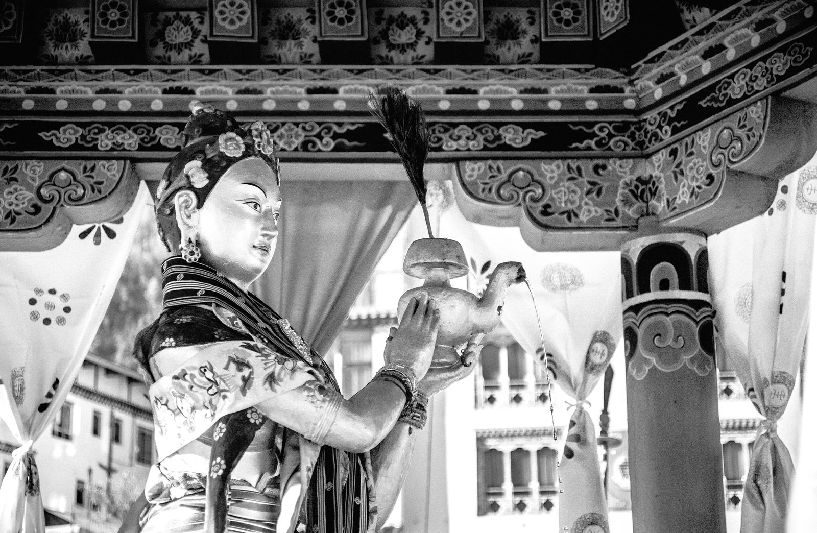 A statue of a goddess holding teapot