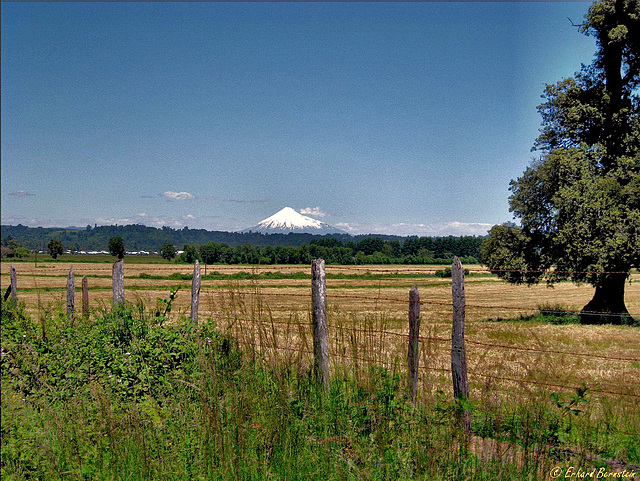 Volcano behind barbed wire fence