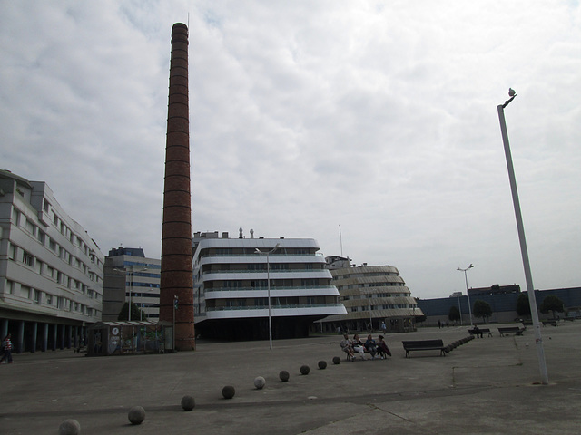 Old chimney and modern buildings.