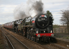 70013 OLIVER CROMWELL running as 70048 THE TERRITORIAL  ARMY 1908- 1958 and 8F 48151 on 1Z27 York to Lancaster at Church Fenton 27th March 2010