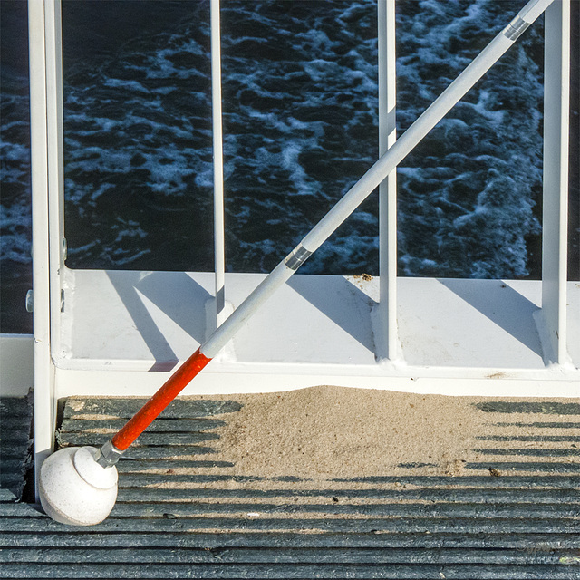 White Cane and Sand at the Fence