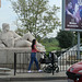 Stone gent and walking woman