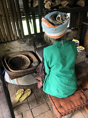 Woman roasting coffee.