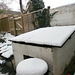 The coal bunker had at least 3" of snow on its top