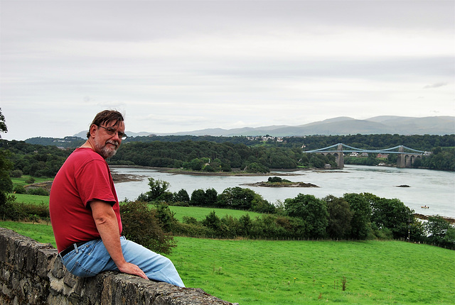 Sitting on a wall overlooking Menai straits