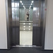 elevator doors opening; inside is a mirror