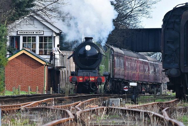 The fireman takes the single line token from the signalman at Sheringham West