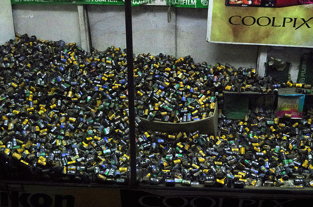 Old 35mm film cans in a shop window