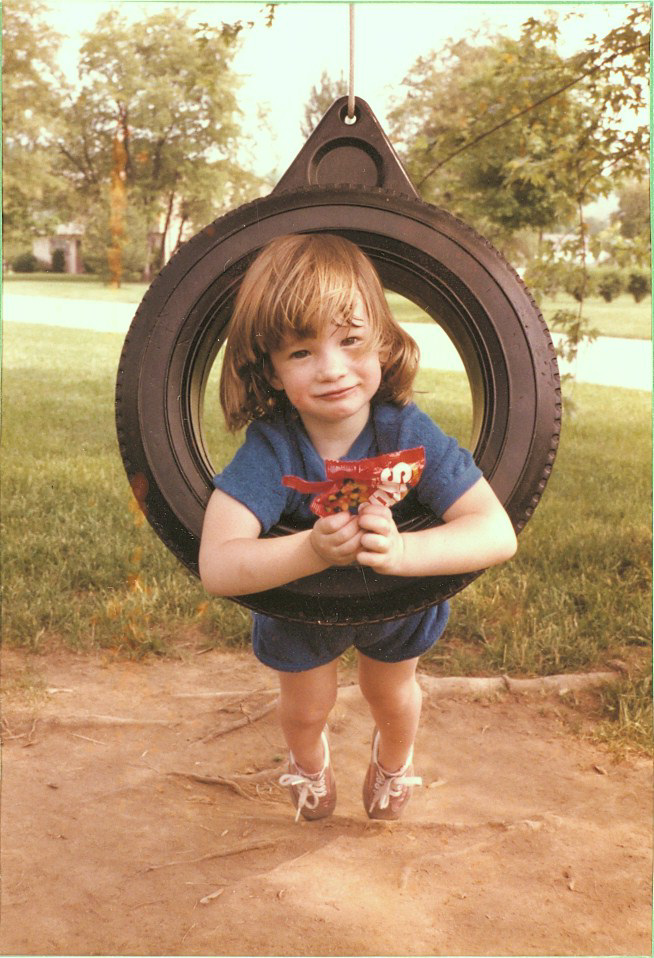 Emily, in the swing with Skittles. 1984